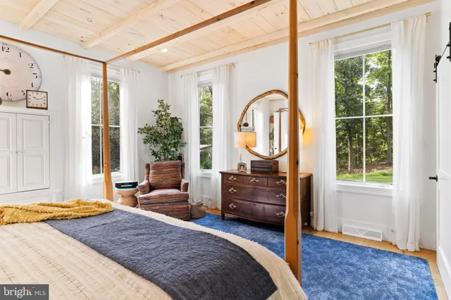 a bedroom with furniture and a window