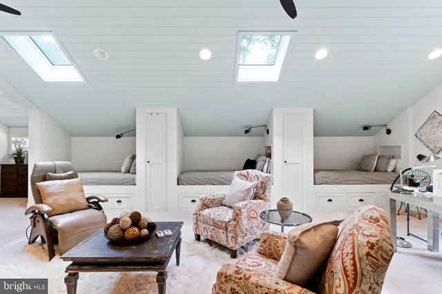 a living room with a dresser and a mirror