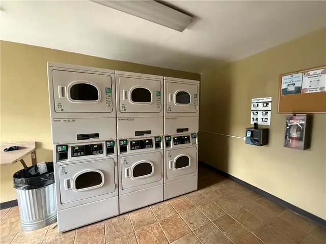 a view of a swimming pool with chairs and table