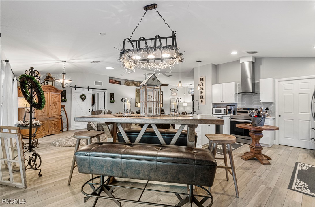 4656 Varsity Circle Lehigh Acres, FL 33971 - Photo 13 of 49 a view of a kitchen and dining room