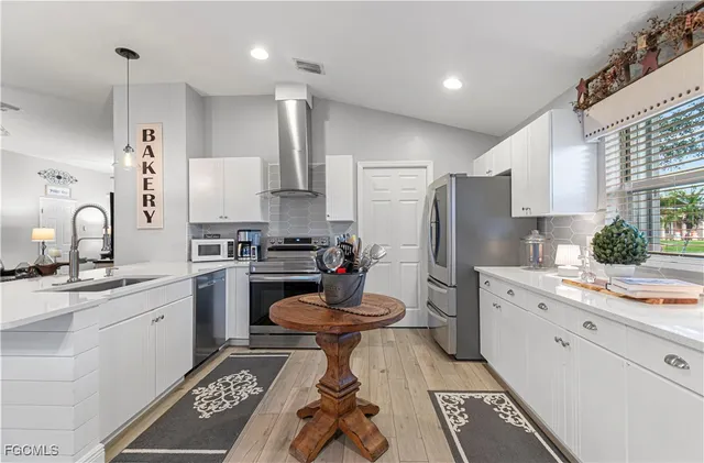 a kitchen with a sink appliances and cabinets