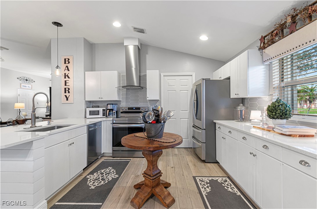 4656 Varsity Circle Lehigh Acres, FL 33971 - Photo 18 of 49 a kitchen with a sink appliances and cabinets