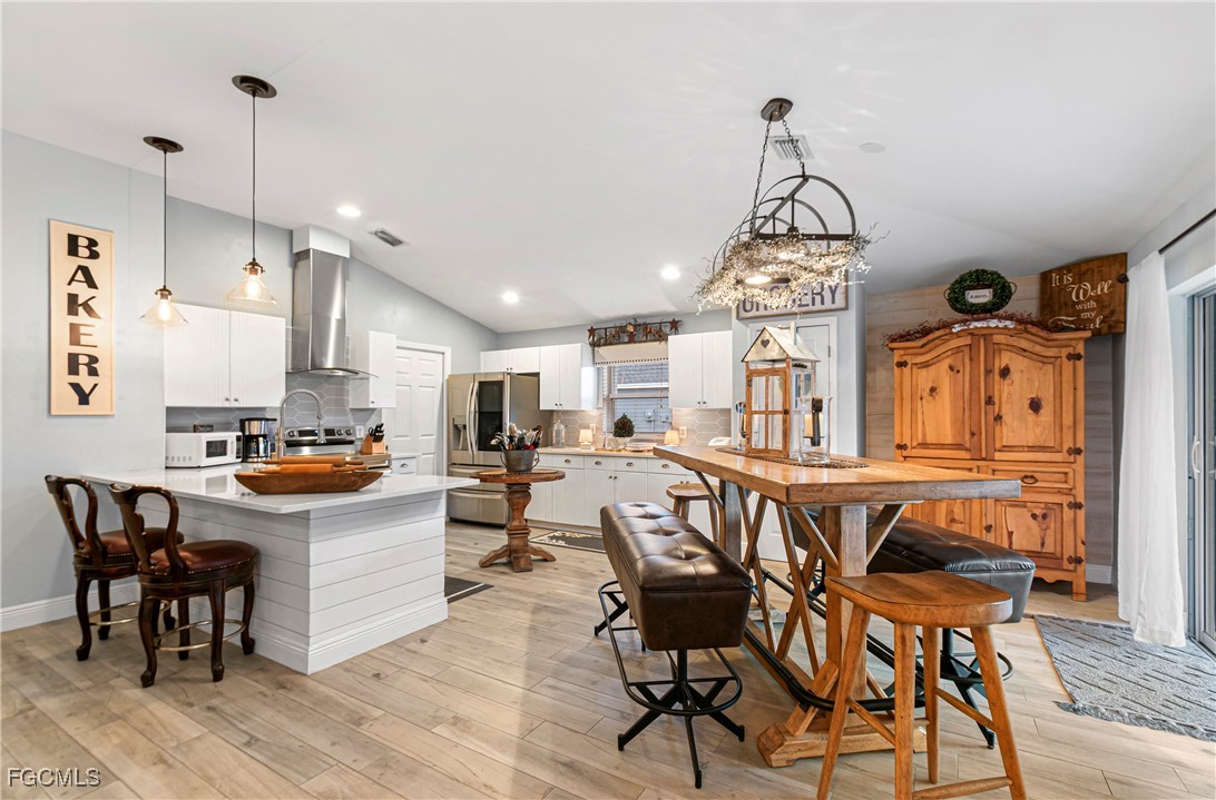 4656 Varsity Circle Lehigh Acres, FL 33971 - Photo 19 of 49 a view of a dining room with furniture window and wooden floor