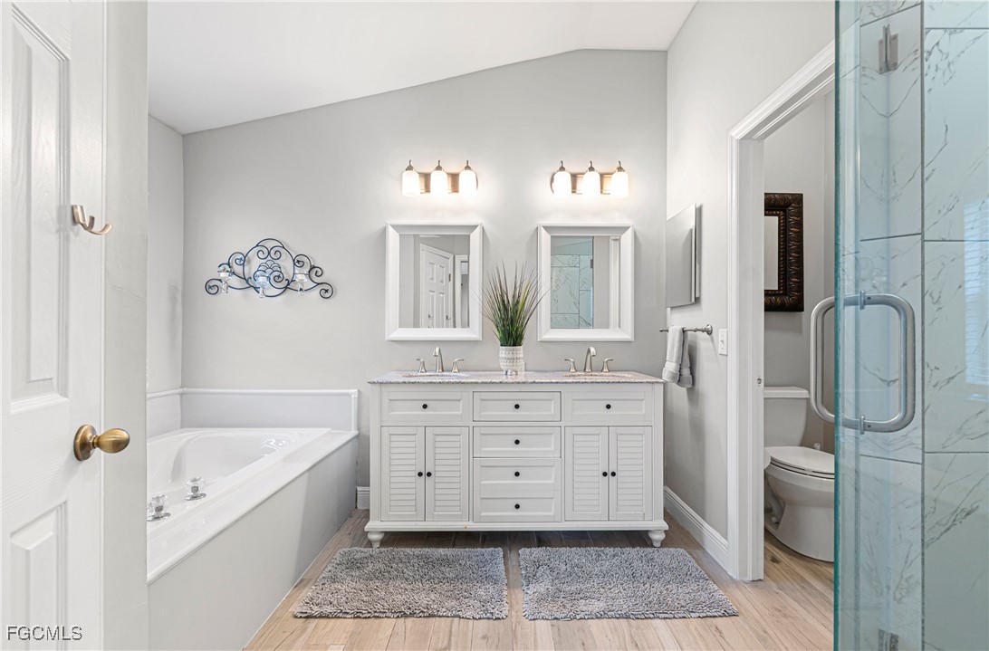4656 Varsity Circle Lehigh Acres, FL 33971 - Photo 23 of 49 a spacious bathroom with a tub sink and mirror