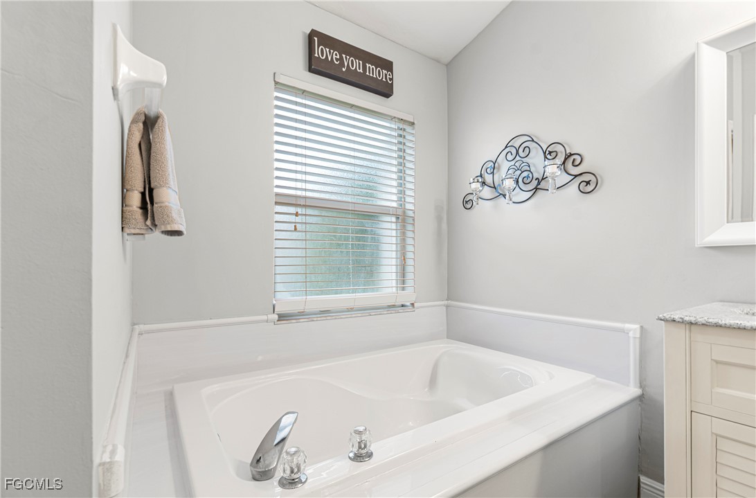 4656 Varsity Circle Lehigh Acres, FL 33971 - Photo 24 of 49 a white bath tub sitting next to a window