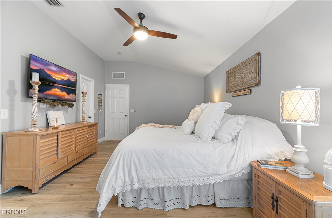 4656 Varsity Circle Lehigh Acres, FL 33971 - Photo 25 of 49 a bedroom with a bed and a flat screen tv