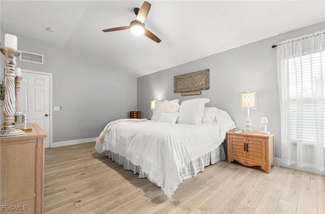 a bedroom with a bed and a night stand