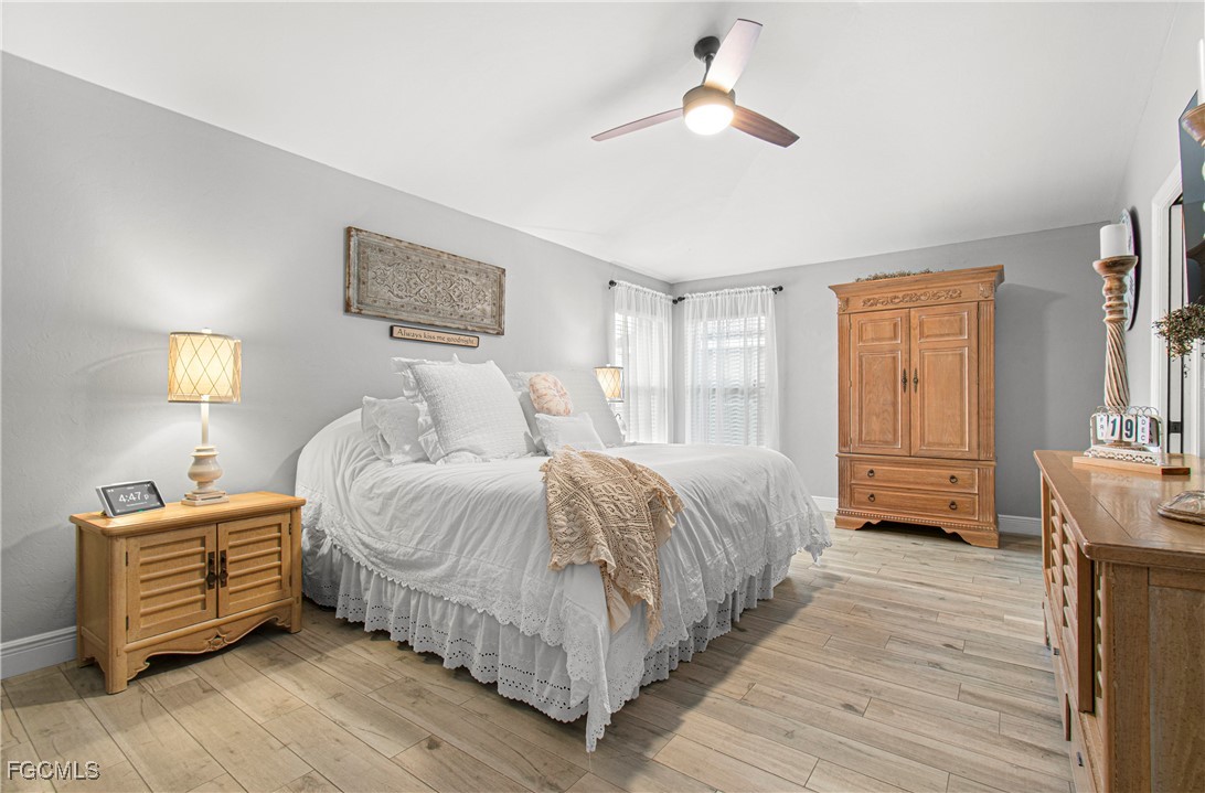 4656 Varsity Circle Lehigh Acres, FL 33971 - Photo 27 of 49 a bedroom with a bed chandelier and a window