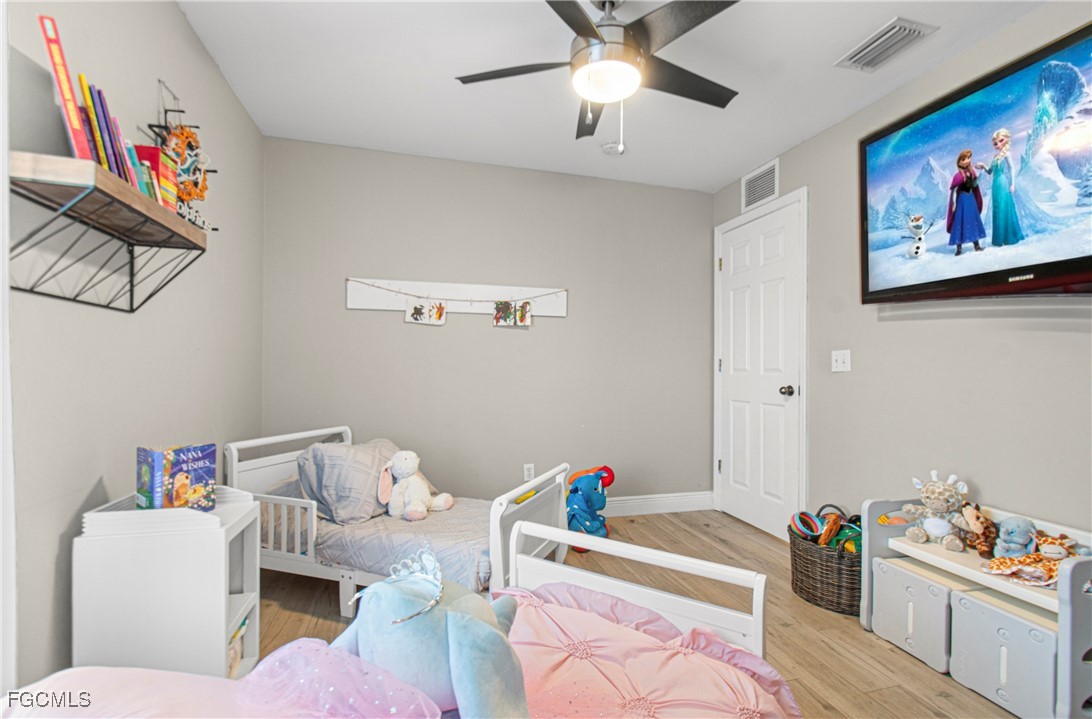 4656 Varsity Circle Lehigh Acres, FL 33971 - Photo 29 of 49 a living room with furniture and baby toys