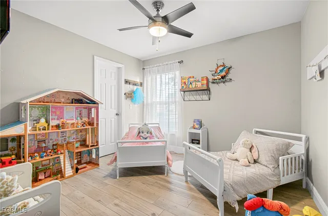 a bedroom with furniture and a baby crib
