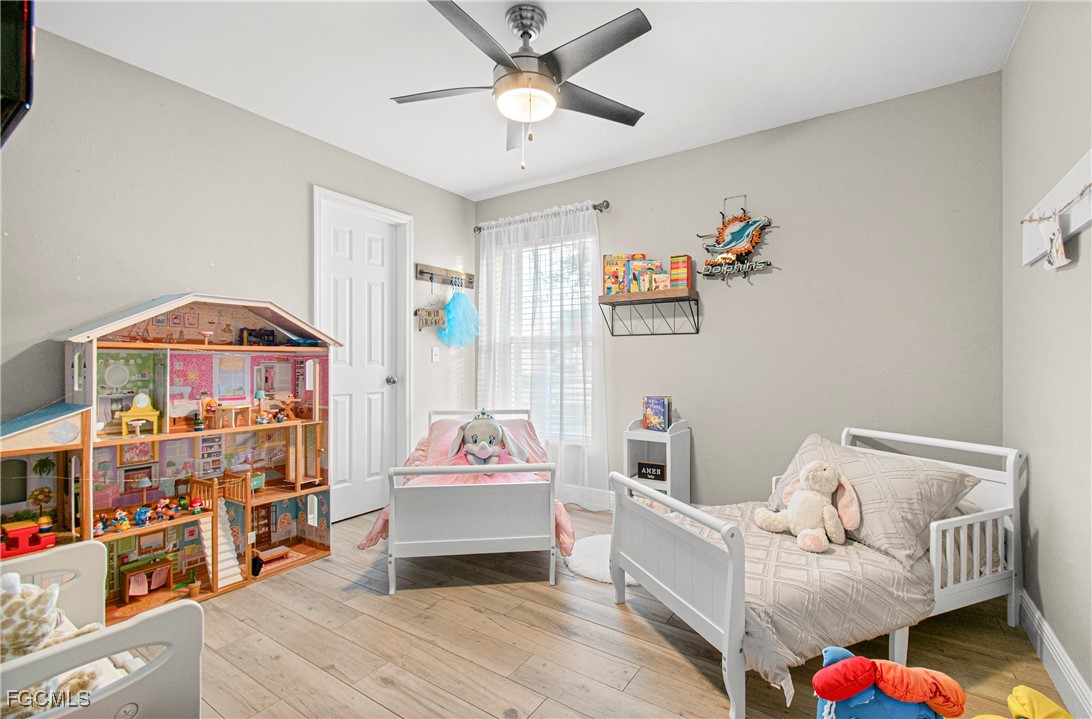 4656 Varsity Circle Lehigh Acres, FL 33971 - Photo 30 of 49 a bedroom with furniture and a baby crib