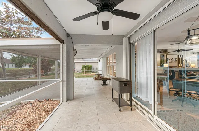 a view of a hallway and a livingroom with furniture