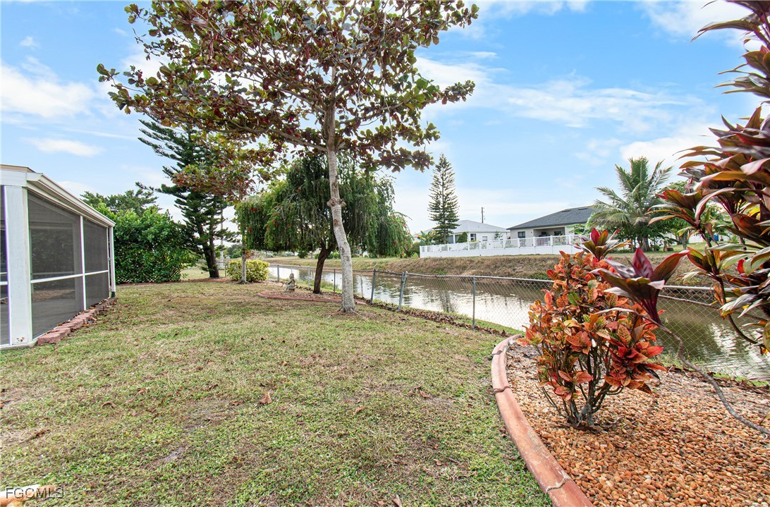 4656 Varsity Circle Lehigh Acres, FL 33971 - Photo 40 of 49 a view of a yard with large trees