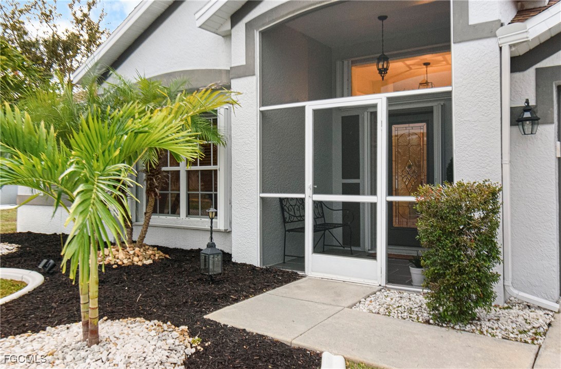 4656 Varsity Circle Lehigh Acres, FL 33971 - Photo 4 of 49 a view of front door and potted plants