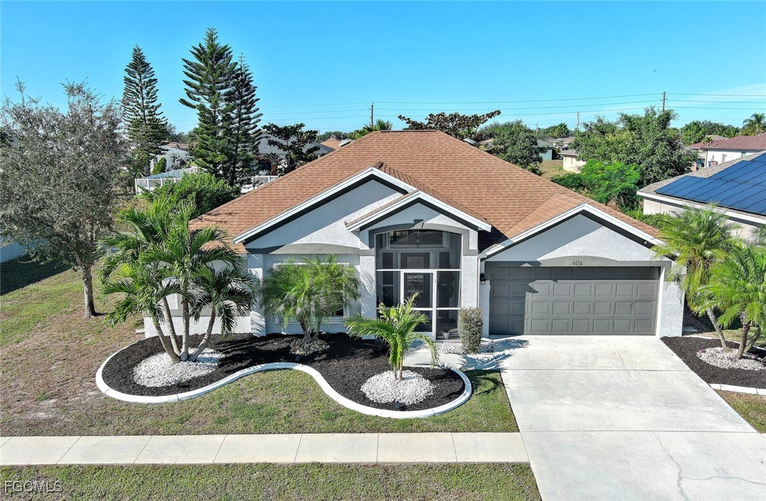 4656 Varsity Circle Lehigh Acres, FL 33971 - Photo 44 of 49 a backyard of a house with seating space