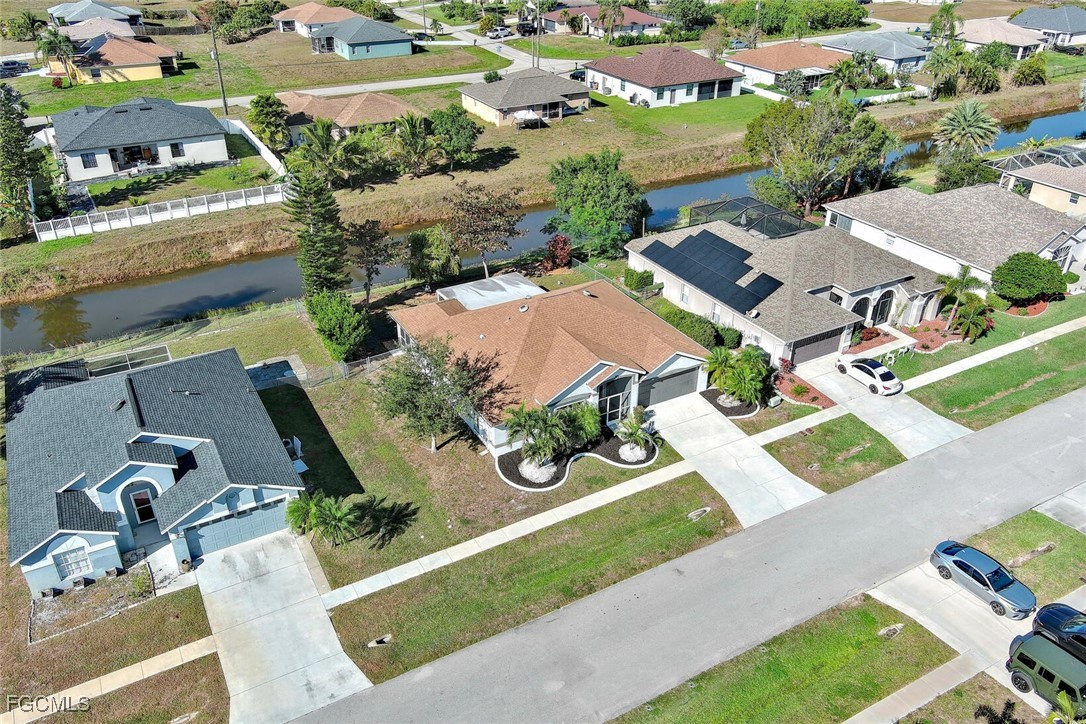 4656 Varsity Circle Lehigh Acres, FL 33971 - Photo 46 of 49 an aerial view of residential house with outdoor space and parking