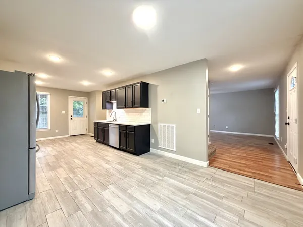 a view of a kitchen with a sink and a refrigerator
