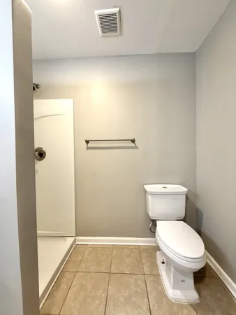 a bathroom with a glass shower door