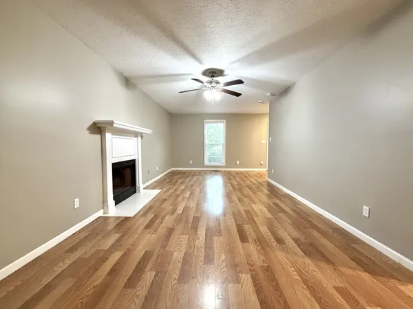 wooden floor in an empty room with a fireplace