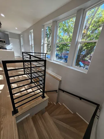 a view of a room with wooden floor and windows