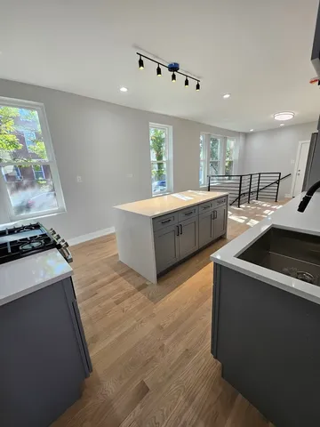 a living room with stainless steel appliances furniture and a large window