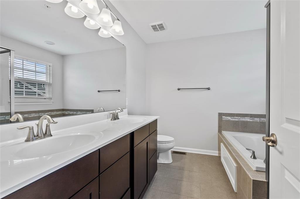 1402 Pointe View Drive Mars, PA 16046 - Photo 15 of 25 a bathroom with a tub a sink and mirror