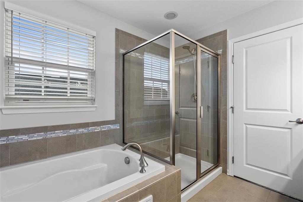 1402 Pointe View Drive Mars, PA 16046 - Photo 16 of 25 a bathroom with a bathtub and a shower