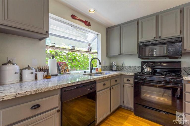560 Fairfield Road Simi Valley, CA 93065 - Photo 12 of 32 a kitchen with granite countertop cabinets stainless steel appliances and a sink
