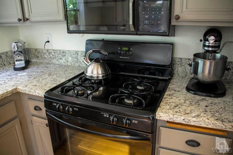 560 Fairfield Road Simi Valley, CA 93065 - Photo 13 of 32 a kitchen with a stove and a microwave