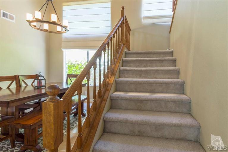 560 Fairfield Road Simi Valley, CA 93065 - Photo 19 of 32 a view of staircase with lots of frames on wall and wooden floor