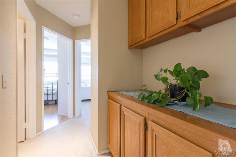 560 Fairfield Road Simi Valley, CA 93065 - Photo 24 of 32 a bathroom with a granite countertop white cabinets and a potted plant