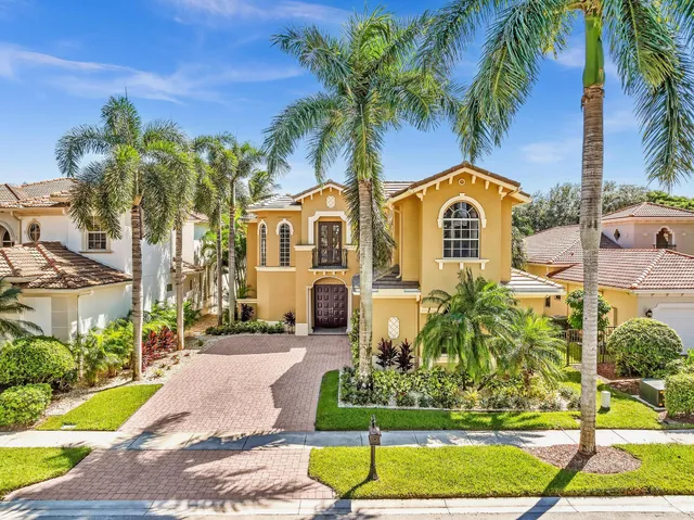 an aerial view of a house with a yard and outdoor seating
