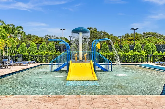 a view of a hallway with wooden floor and a chandelier