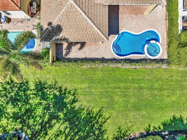a view of a patio with swimming pool table and chairs