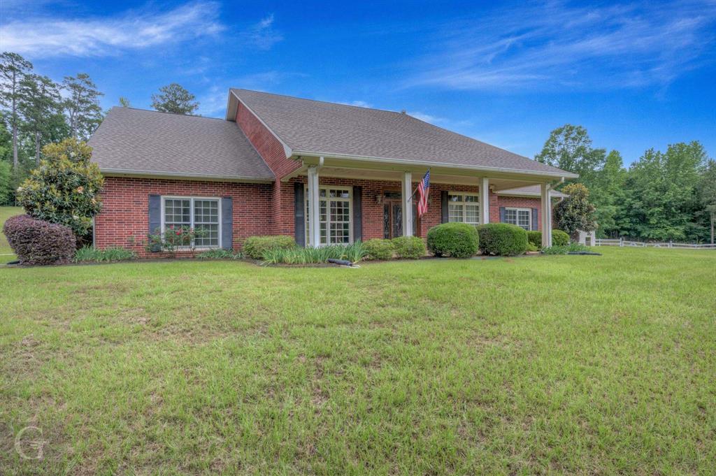 1212 WPA Road Homer, LA 71040 - Photo 3 of 35 View of front of home featuring a front yard, brick siding, and a shingled roof