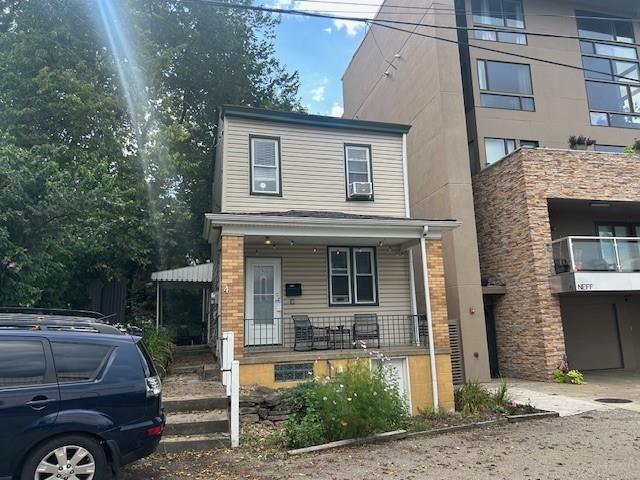 a front view of a house with parking space