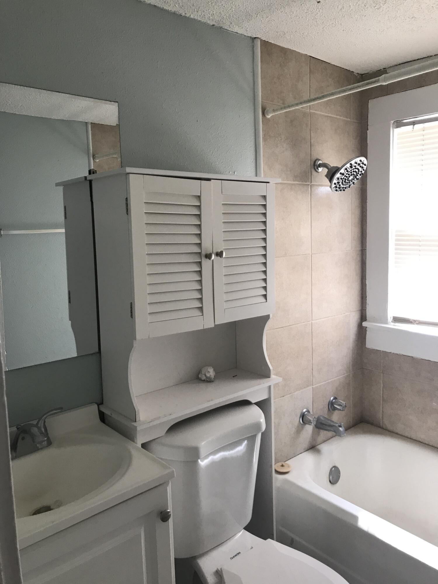 2312 15th Street Lubbock, TX 79401 - Photo 13 of 20 a bathroom with a sink and a bathtub