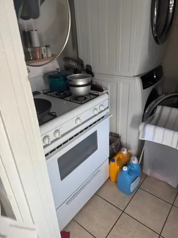 a stove top oven sitting inside of a kitchen