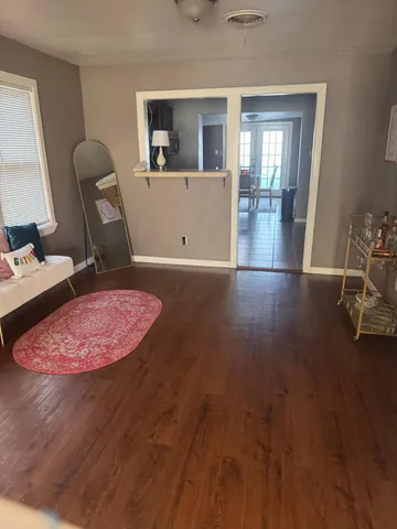 a view of a workspace with furniture and wooden floor