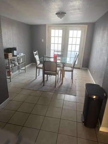 a view of a dining room with furniture and window