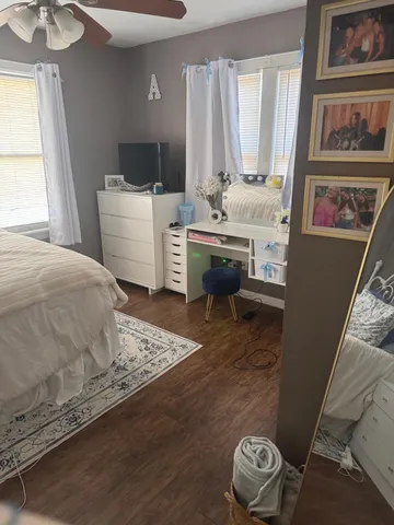 a bedroom with a bed and a window