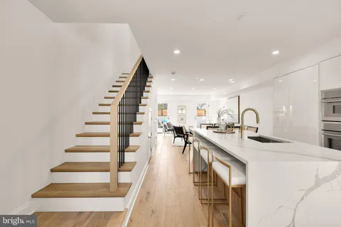 a very nice looking kitchen with wooden floor and a sink