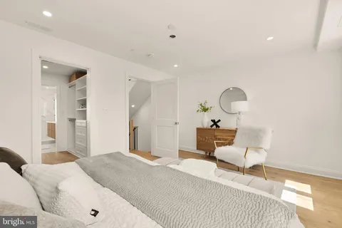 a view of walk in closet with wooden floor