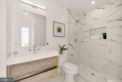 a bathroom with a toilet sink and shower