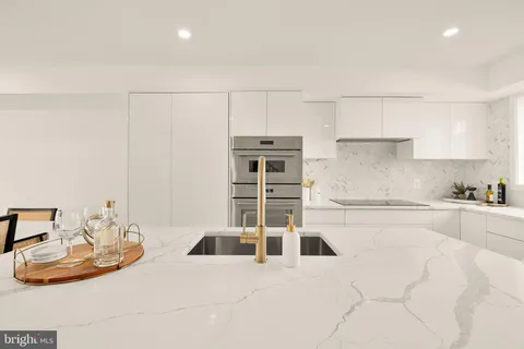 a kitchen with stainless steel appliances kitchen island granite countertop a sink and cabinets