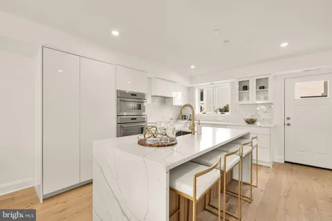 a kitchen with stainless steel appliances granite countertop a sink and cabinets