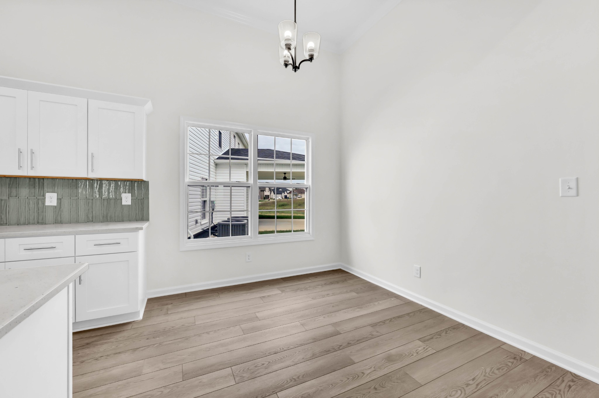 2555 Rafiki Drive Clarksville, TN 37042 - Photo 13 of 42 a kitchen with granite countertop white cabinets and wooden floor
