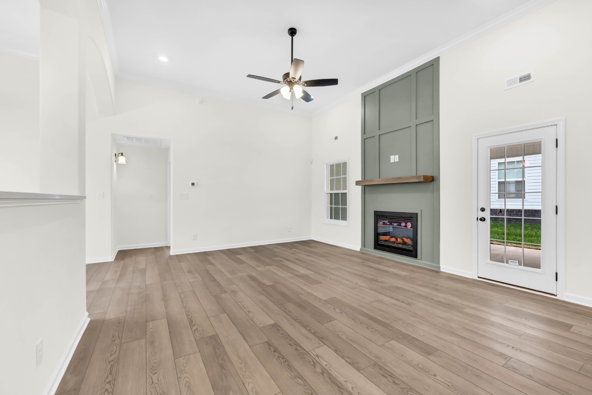 2555 Rafiki Drive Clarksville, TN 37042 - Photo 9 of 42 a view of an empty room with wooden floor fireplace and a window