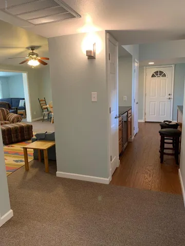 a view of a livingroom with furniture and a bathroom
