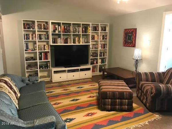 a living room with couches and a flat screen tv